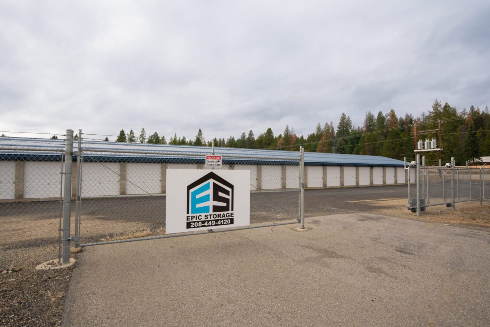 hwy-1 Storage facility entrance with chain-link fence.