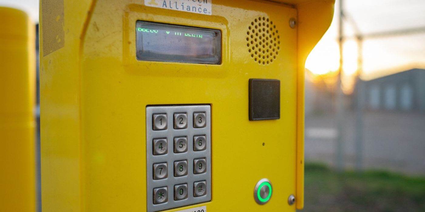 4-1 Yellow security keypad at a gated entrance.