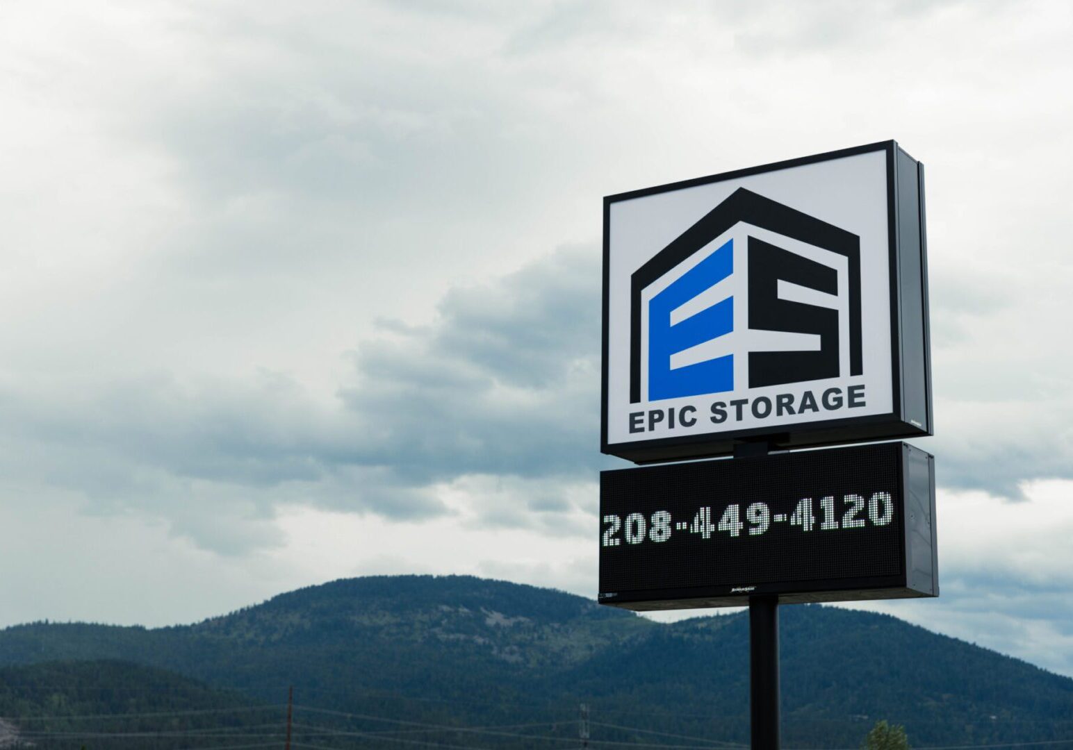 Storage company sign with mountain backdrop.